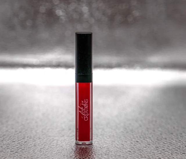 Red Adeja gloss on a textured silver surface