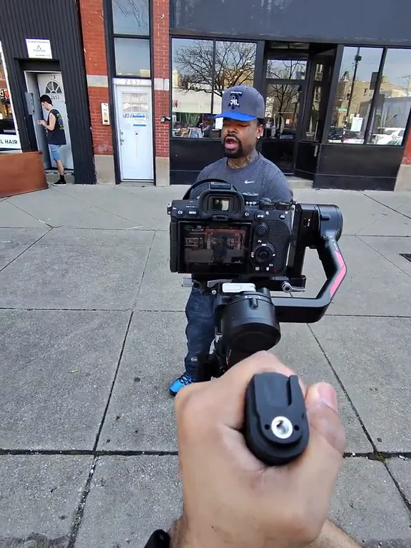A first-person view of the gimbal as an adult speaks outside a storefront.