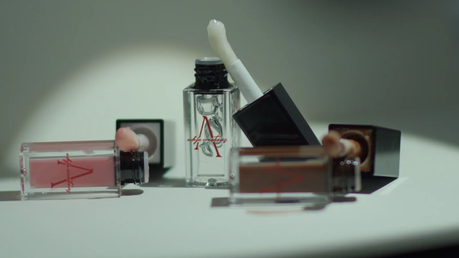 Adeja Creations lip products arranged in a shaft of sunlight.