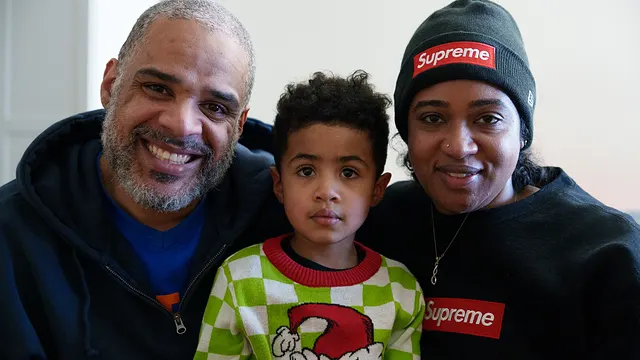 A family of three in front of the tree