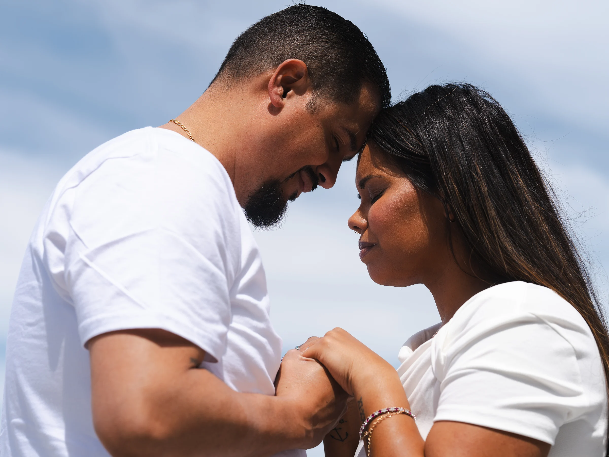 His arms around her, both looking down