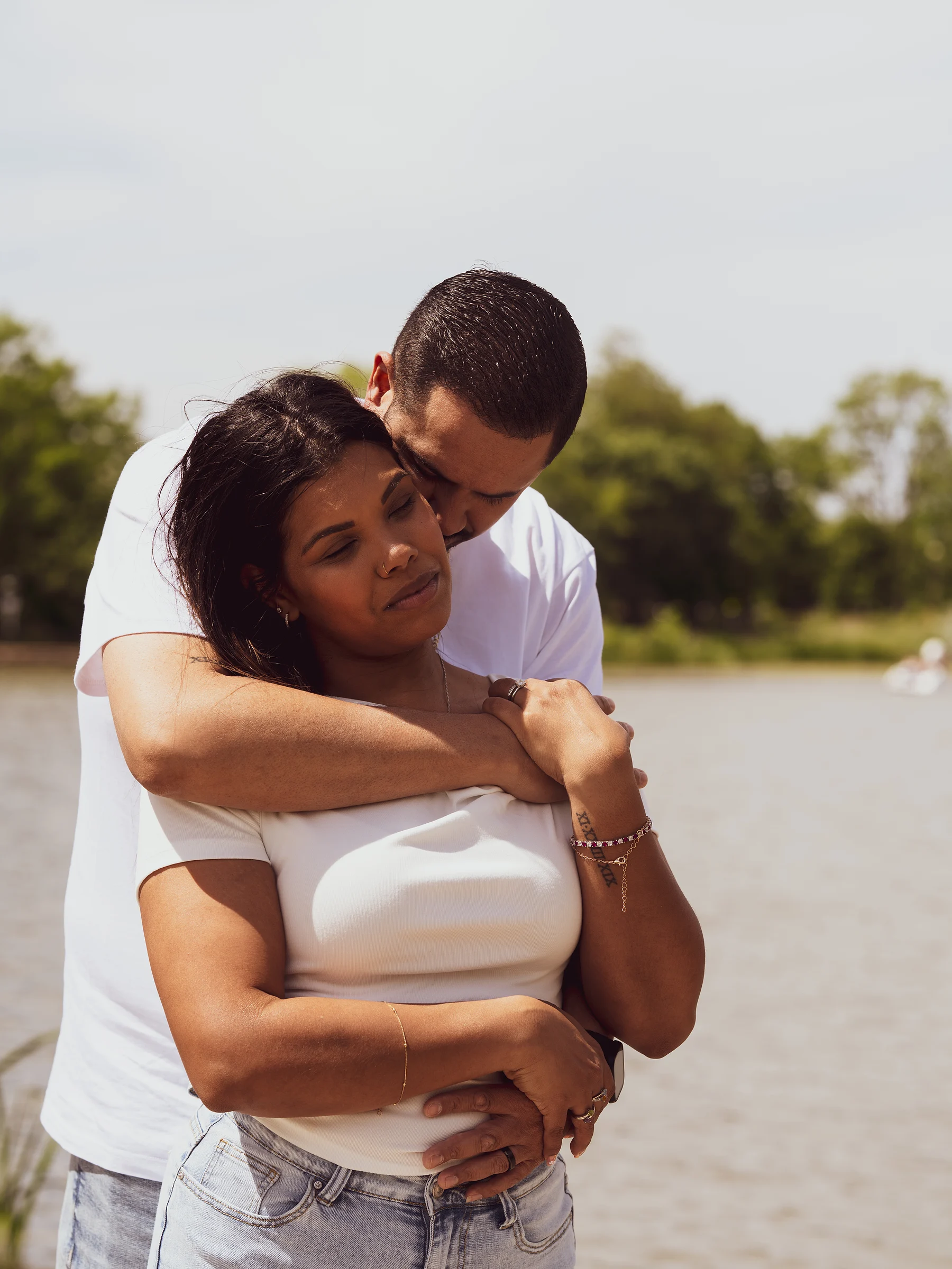 He kisses the top of her head