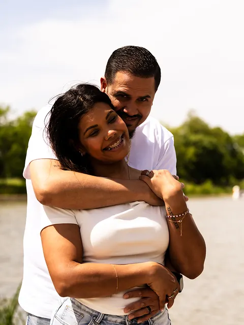 Both laughing, his arms crossed over hers