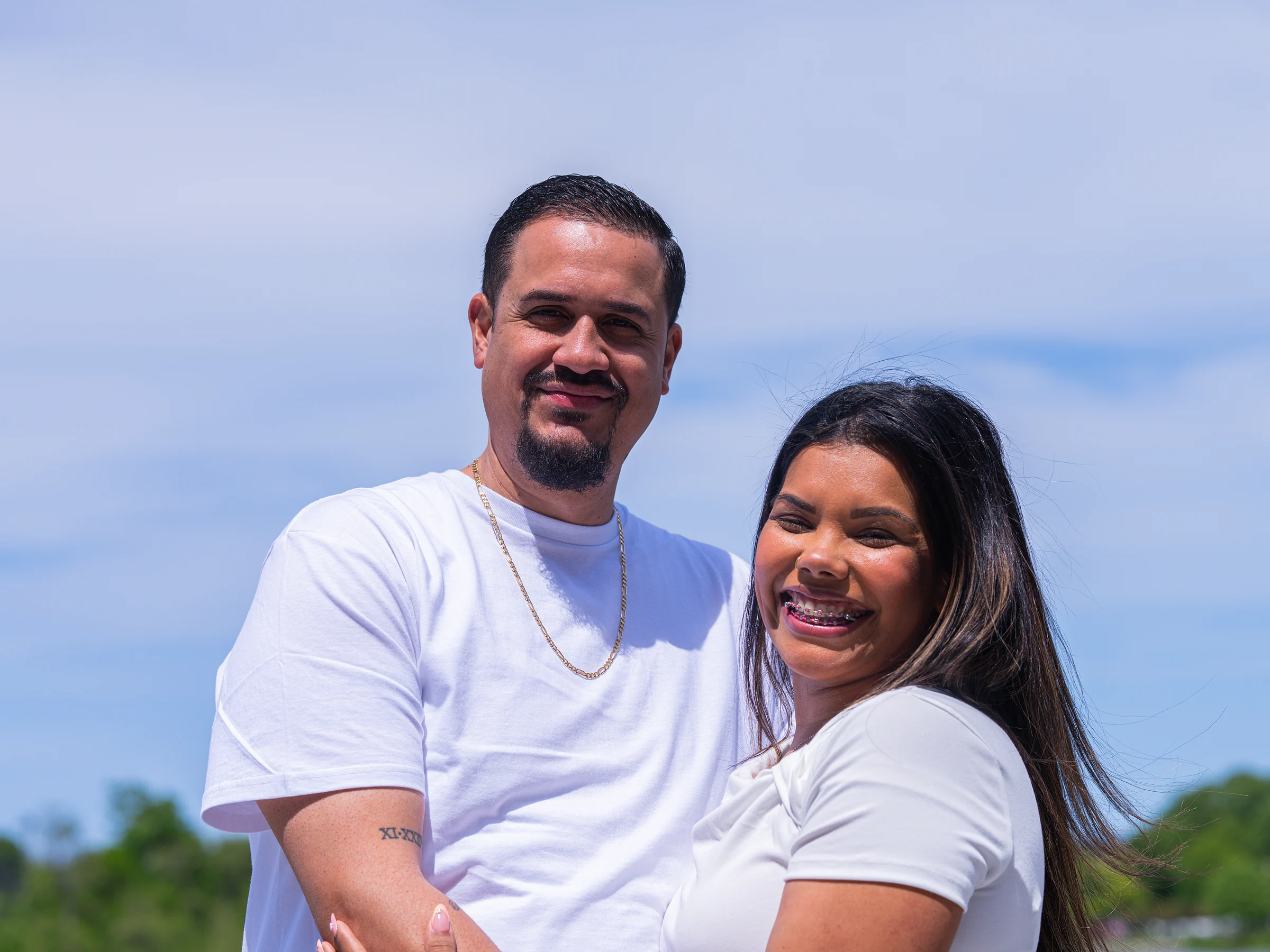 Both to camera, sky behind them