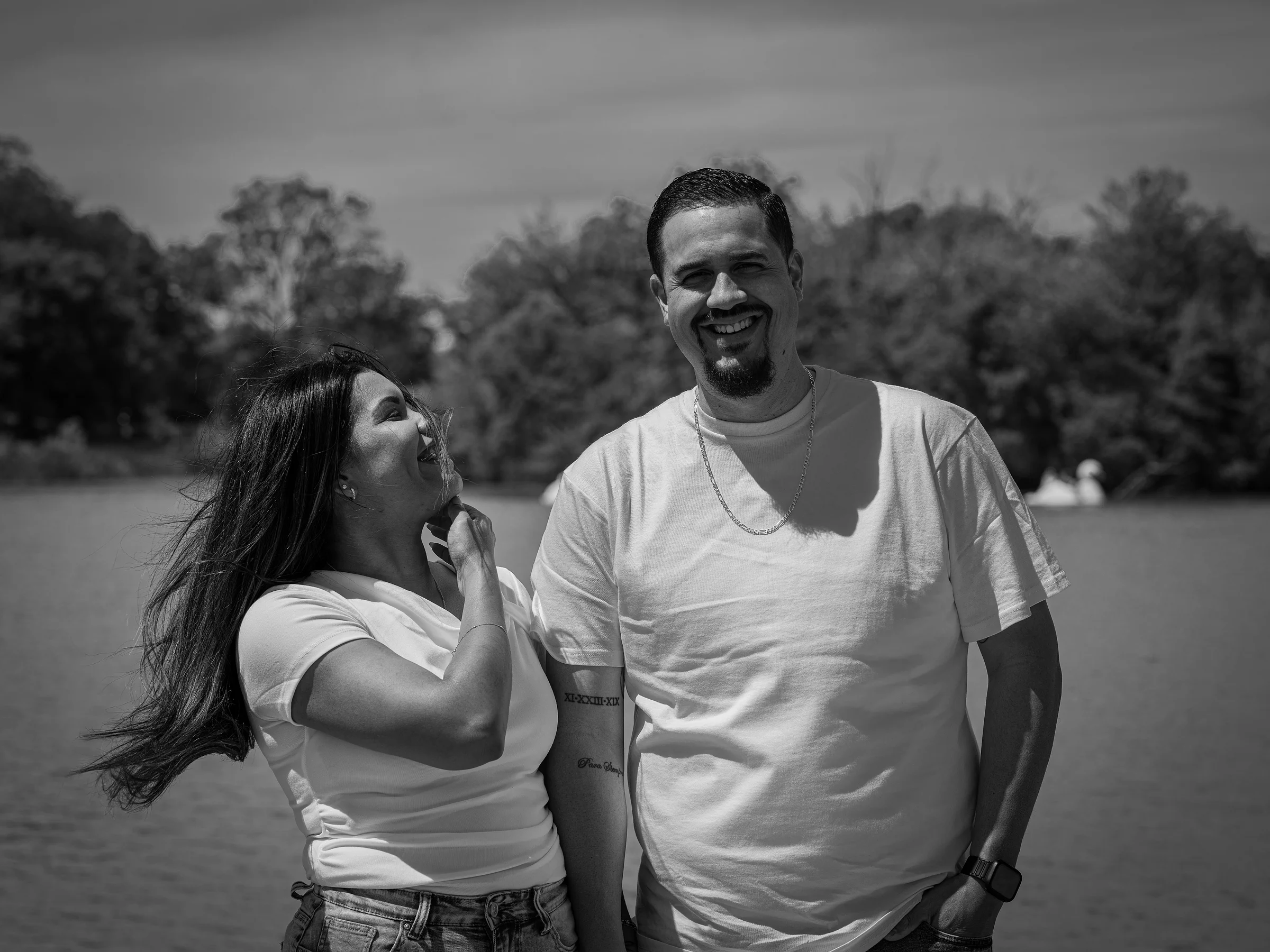 She laughs up at him, in black and white