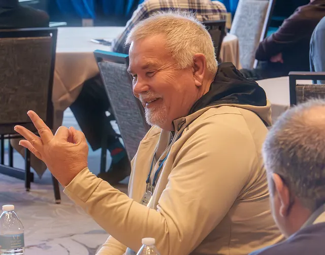 A delegate laughing at the table