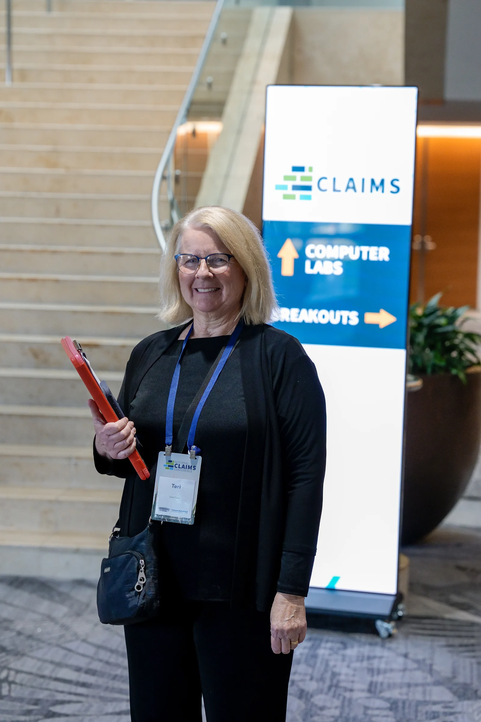 A delegate by the wayfinding sign
