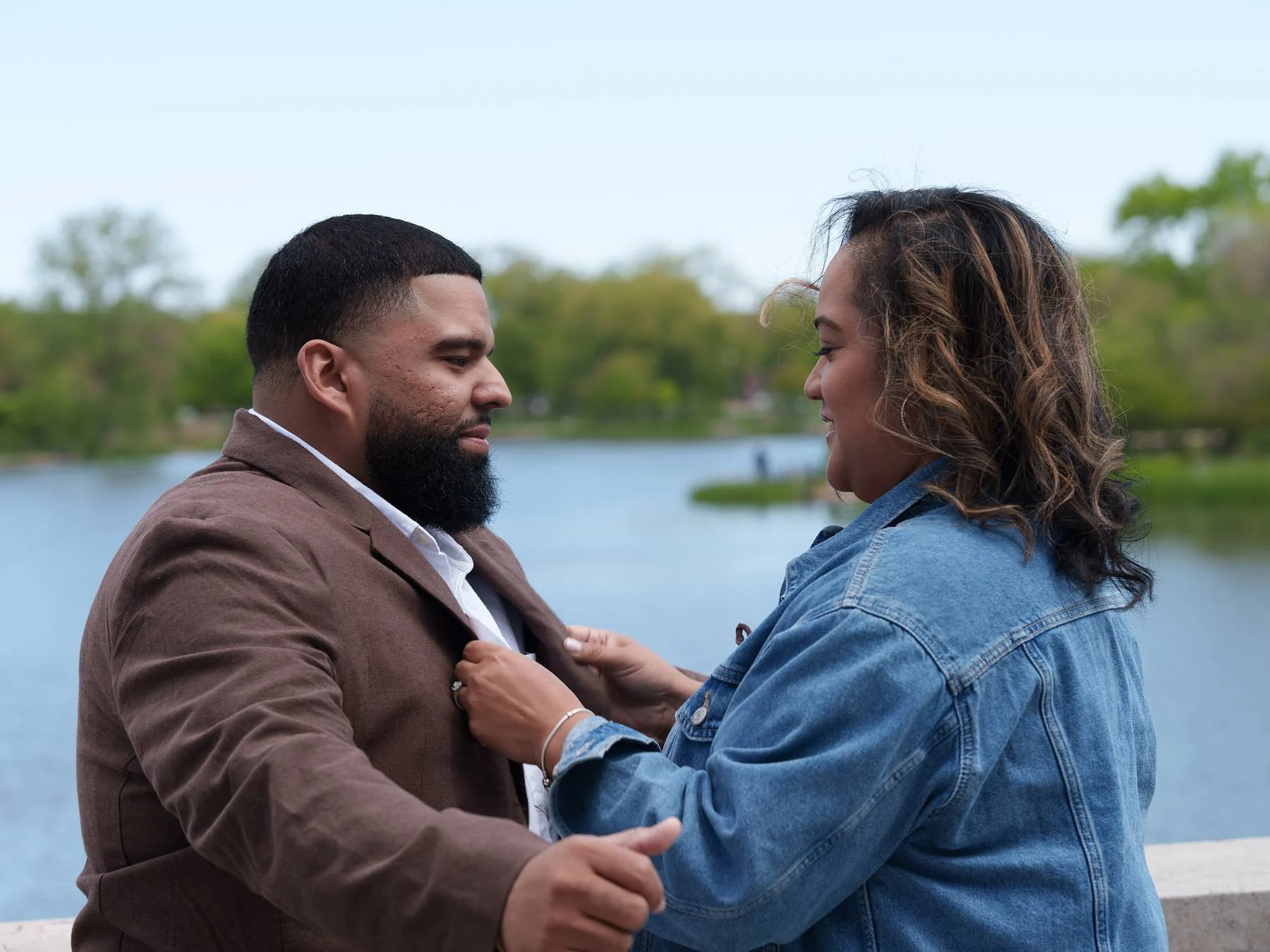 He straightens her collar