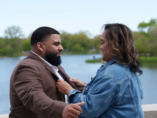 He straightens her collar