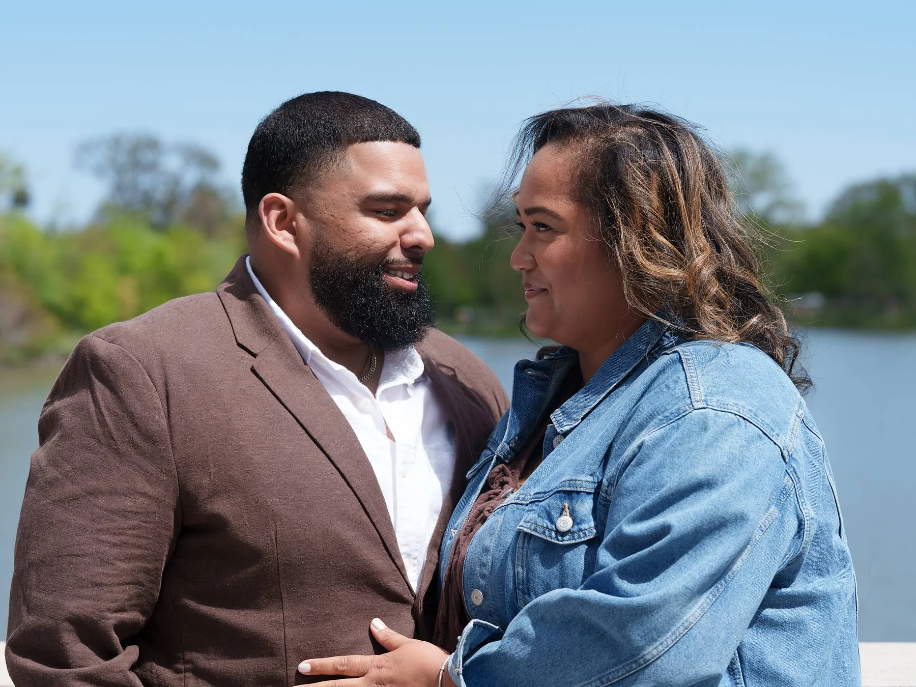 Both laughing, the water behind