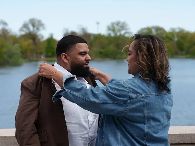 She fixes his jacket