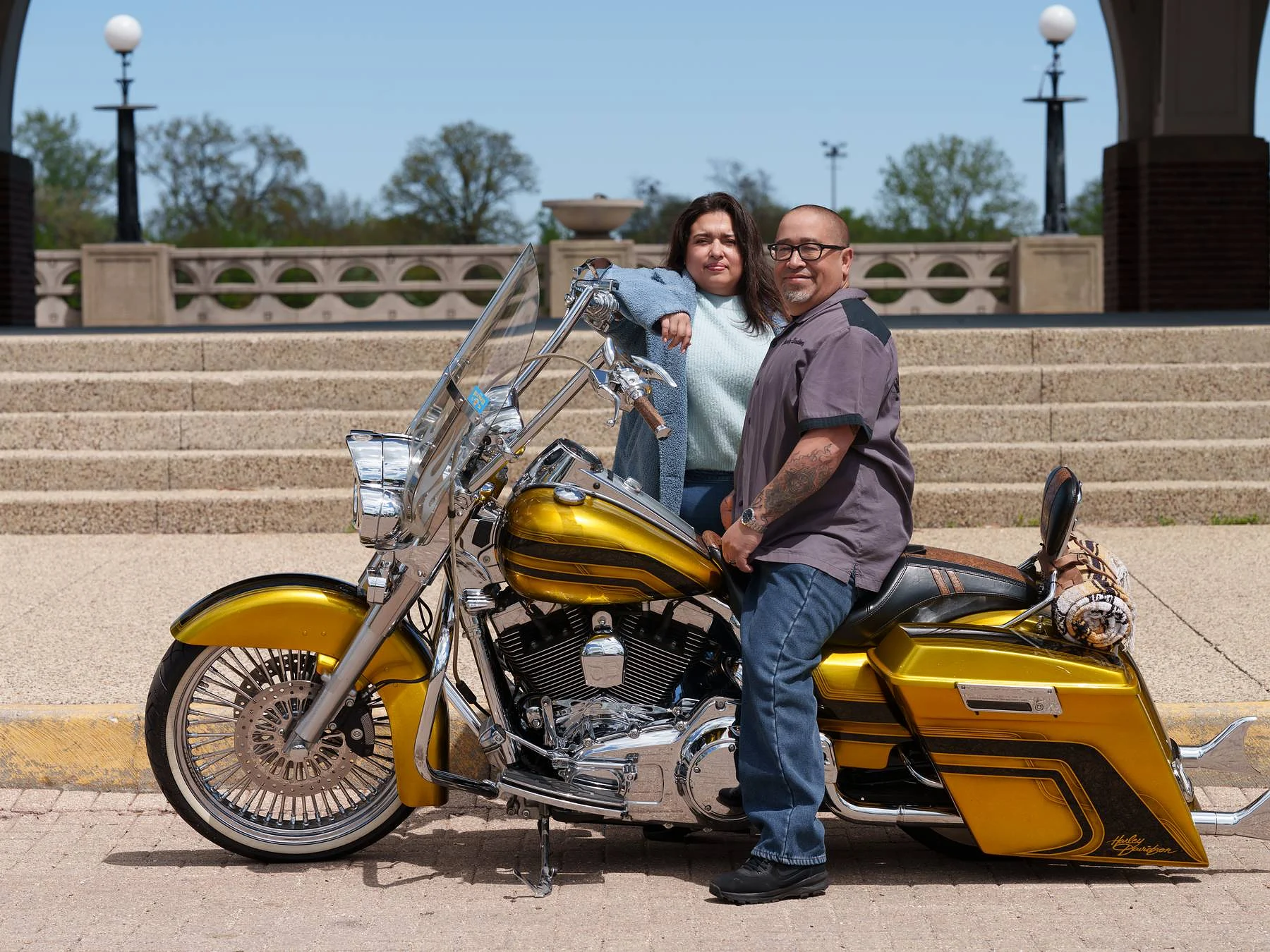 Him on the bike, her at his shoulder