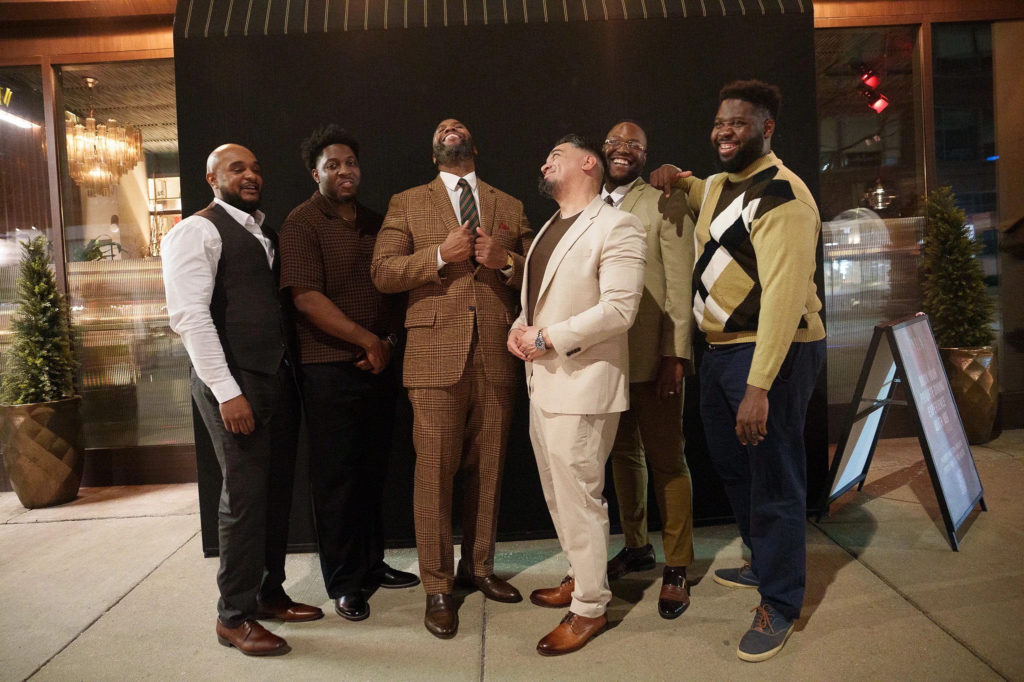 The guys outside on the sidewalk