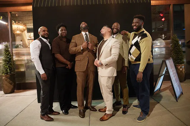 The guys outside on the sidewalk