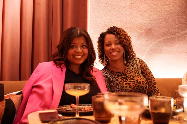 Two friends at the table, drinks poured