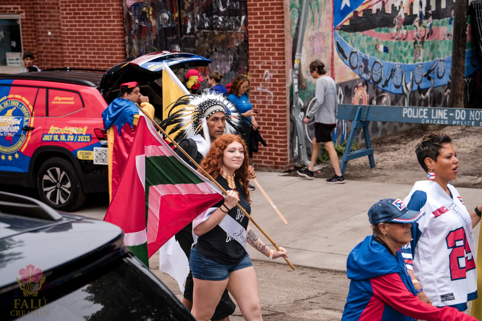 Puerto Rican flags and parade-goers beside a painted Chicago wall.