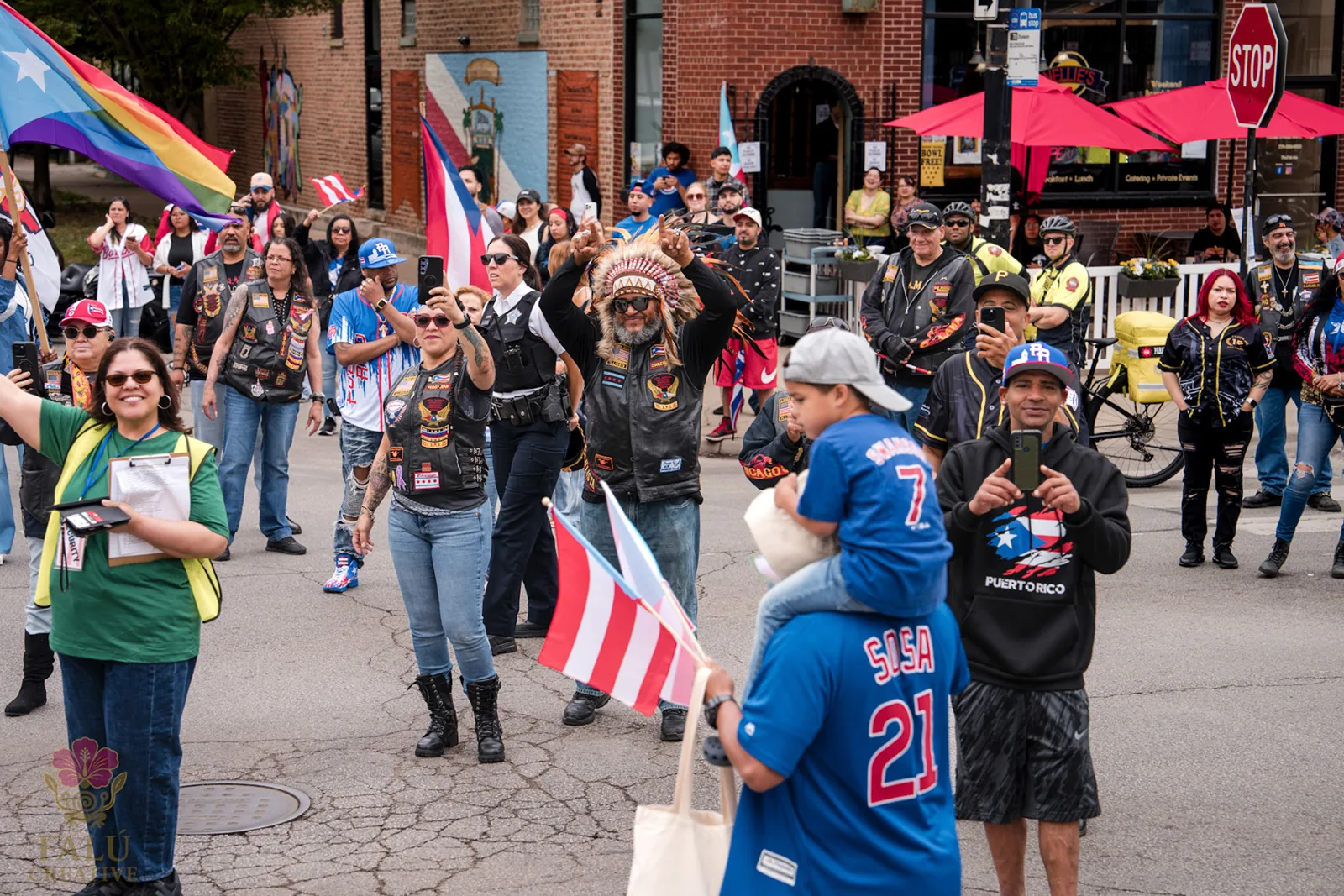 A crowd filling the street beneath Puerto Rican flags.