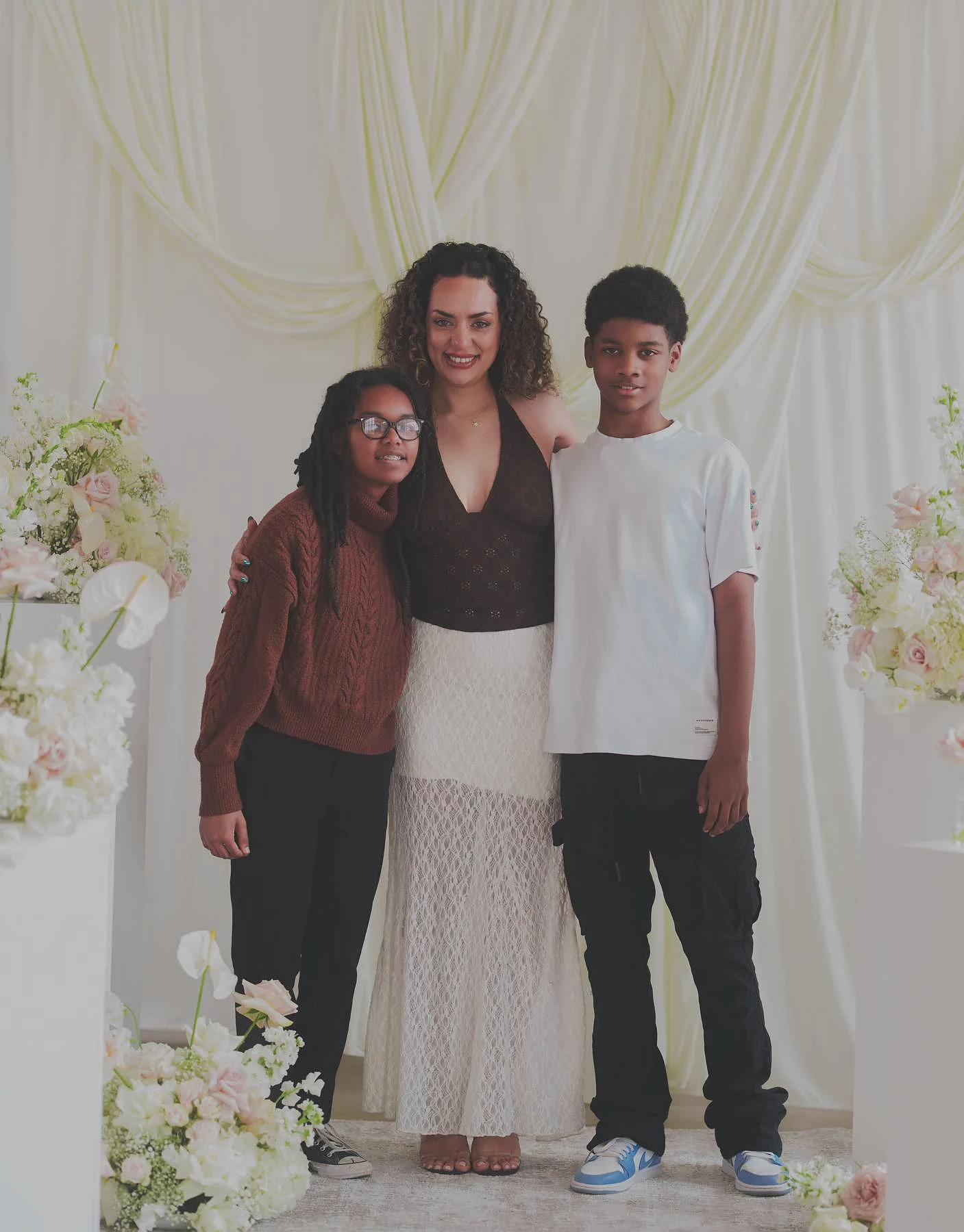 A mother and her two, by the flowers