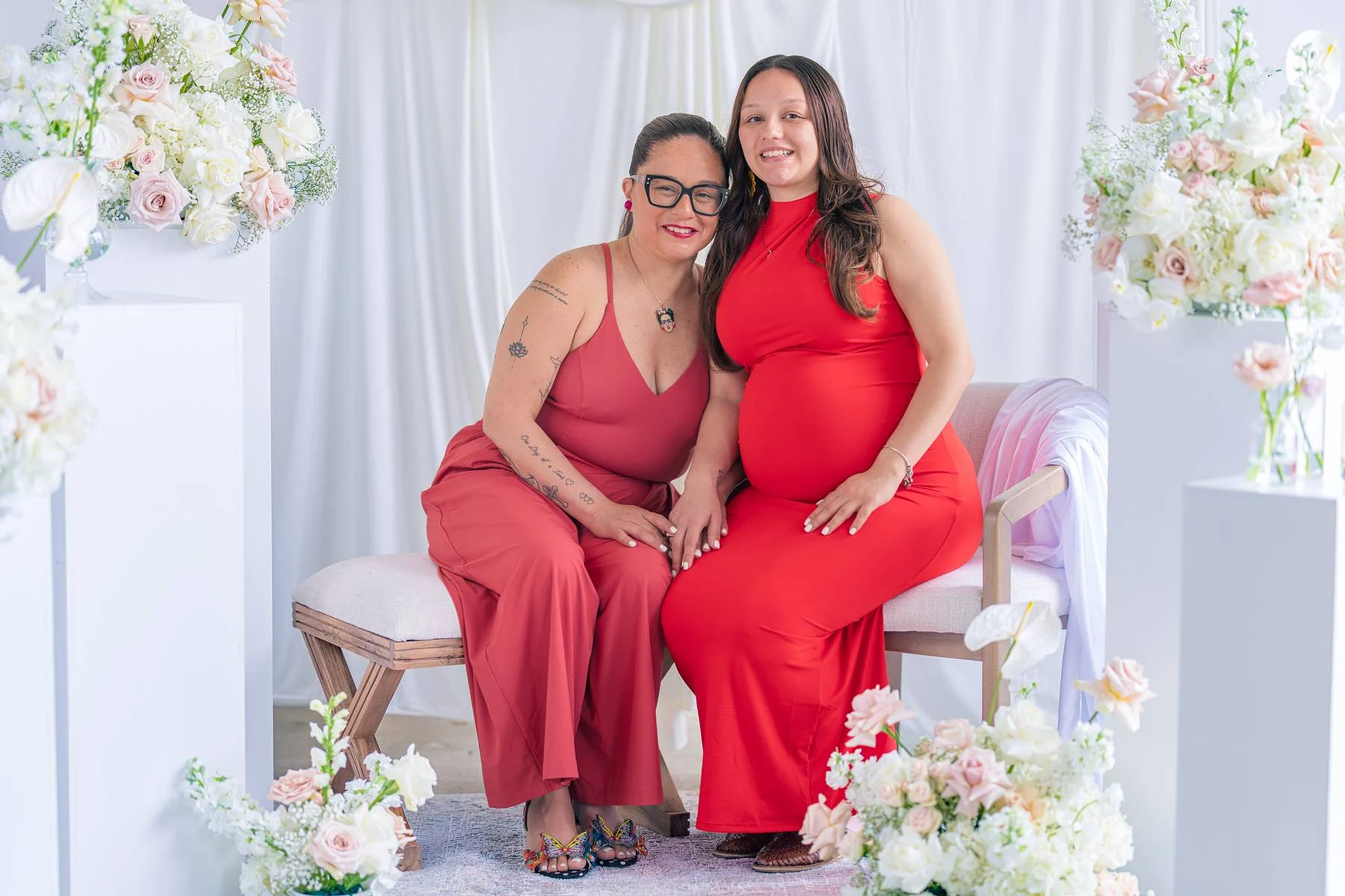 Two women on the bench, one expecting