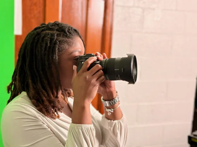 A client in a white top photographing with Riri
