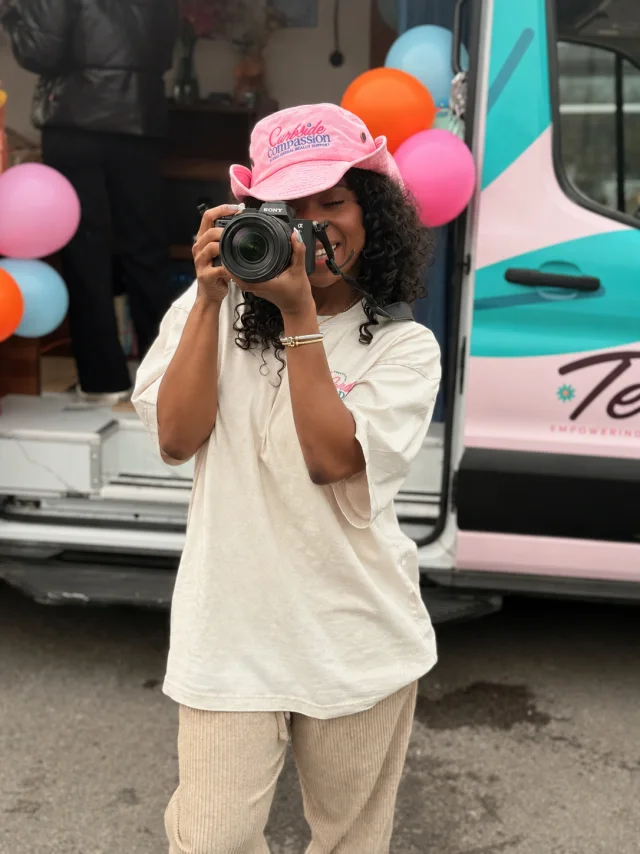 Sarah in a pink cap holding Riri