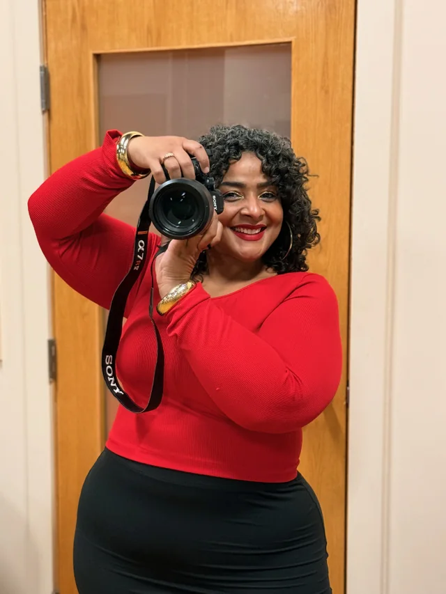 A smiling client in a red top holding Riri